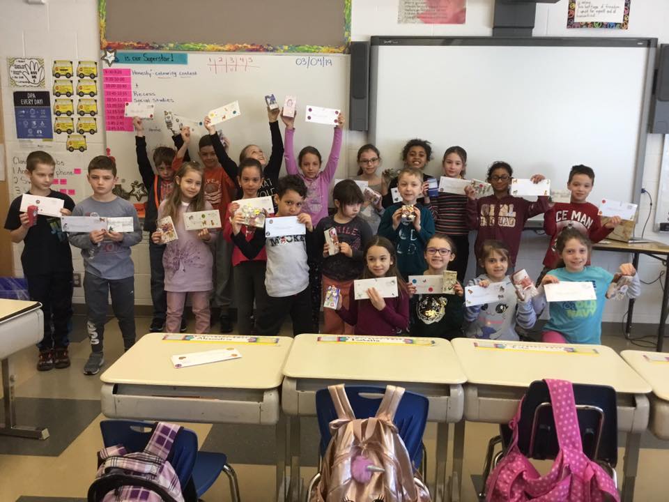 A group of students proudly show off their God Box.